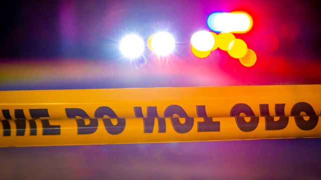 Generic police lights and yellow police tape at crime scene