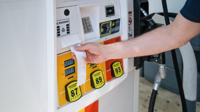 Man Purchases Gas at Pump Amid Skyrocketing Prices