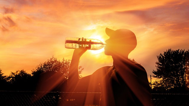 Man drinking water during heat wave 